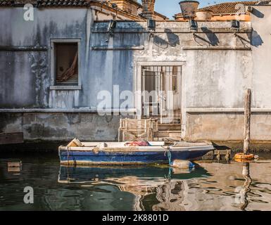 old wooden boat in the Canal, Chioggia town, Venetian Lagoon, Veneto region,northern italy - Europe - boat docked along the canal Stock Photo