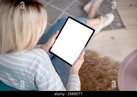 Tablet screen in the hands of woman using a digital tablet Stock Photo
