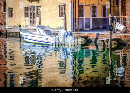 motorboat moored along the canal in Chioggia city, Venetian lagoon, Venice province, Veneto district, northern Italy - Europe Stock Photo