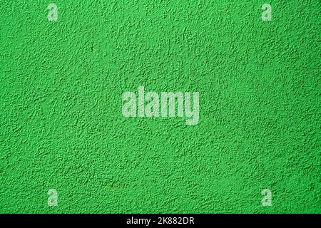 Background of green concrete wall. Decorative embossed concrete and glue plaster. Green plastered wall. Plaster textured background. Blurred photo. Stock Photo