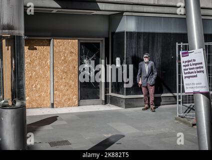 Old Man standing Outside Boarded Up Shops in Bedford Town Centre Stock Photo