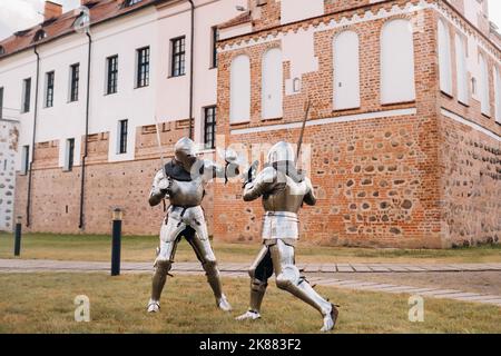 Medieval knights fighting with armor, swords and shields in festival ...