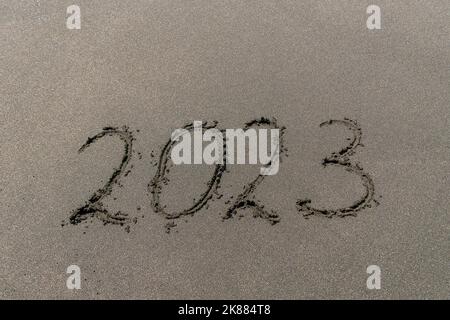 Close-up of the numbers 2023 on the sand, symbols of the new year Stock Photo