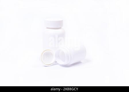 Top view mockup bottle for pills and vitamins with green leaves, Stock Photo