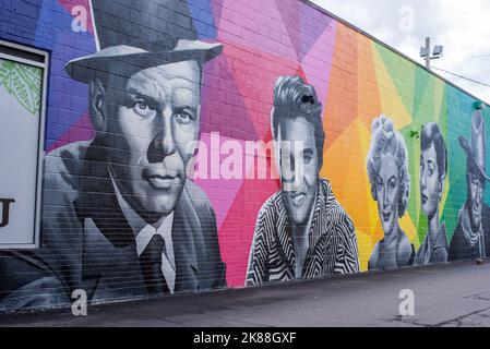 A murual of celebrities appears on the side of a wall of a building in