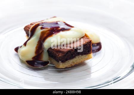 marble sponge cake with creamy custard sauce Stock Photo