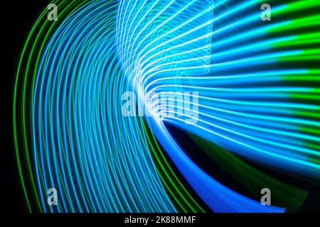 Neon technology stripes. Digital blue and green lines on black background. Stock Photo