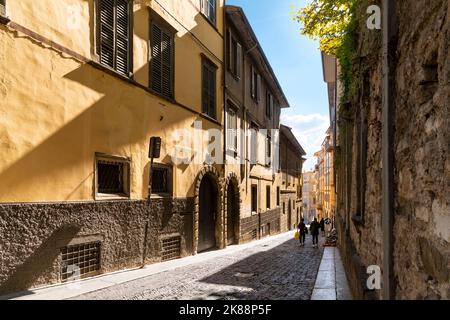 A picturesque narrow alley leading to the historic medieval old town walled Città Alta district, in the city of Bergamo, Italy, in the Lombardy region Stock Photo