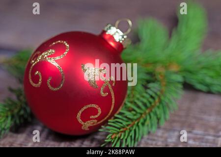 Red Christmas tree ball on spruce branch Stock Photo