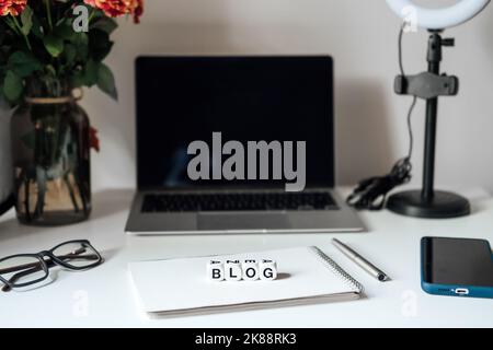 Blogging Equipment. How To Start Blog, Blogging for Beginners. Laptop, Mobile Phone, Ring Light, notebook and glasses on the table Stock Photo