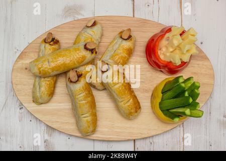 Halloween food with scary faces in bell peppers and with fingers with sausage and cheese Stock Photo