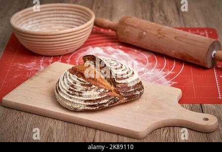 Traditional sourdough bread. Round loaf of freshly backed sourdough bread. Artisan Sourdough bread baked at home. Stock Photo