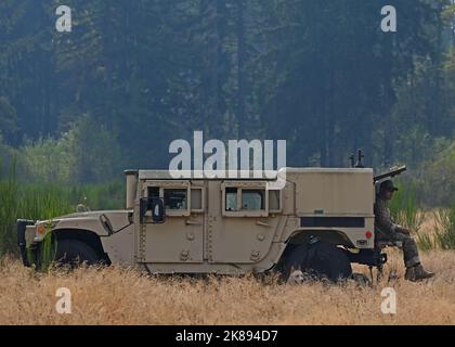 U.S. Air Force Staff Sgt. Ricky Anadilla, tactical air control party member with the 5th Air Support Operations Squadron, rests with his dogs after a night mission during a field training exercise in Yelm, Washington, Oct. 4, 2022. The FTX was designed to test the 5th ASOS’s proficiency in reconnaissance and communication using small unit tactics. (U.S. Air Force photo by Senior Airman Callie Norton) Stock Photo