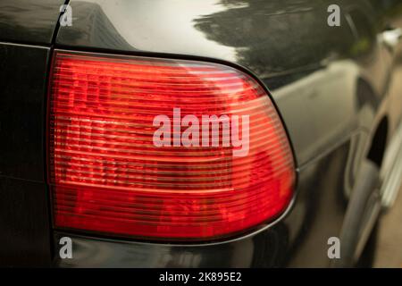 Rear car signal. Headlight machine. Transport details. Light source on road. Rear turn signal. Stock Photo