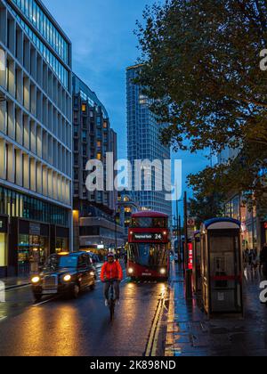 Tottenham Court Road London - evening commuter traffic on Tottenham Court Rd in central London, Euston tower in the background. Stock Photo