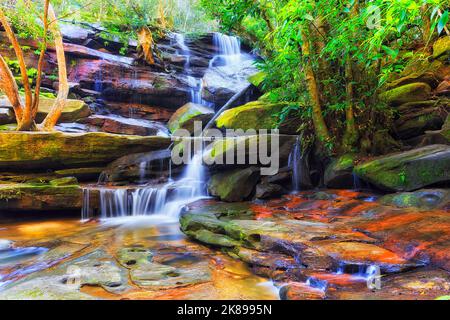 Scenic rocks and waterfall cascade of Somersby falls in rainforest of Australia on the Central coast in NSW. Stock Photo