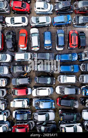 LEEDS, UK - OCTOBER 3, 2022.  Aerial view directly above rows of scrap metal cars involved in traffic accidents in a car insurance concept background Stock Photo