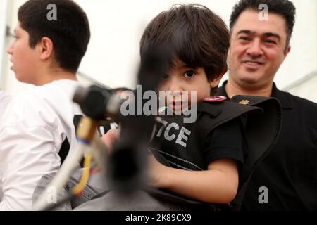 Tehran, Tehran, Iran. 20th Oct, 2022. Iranian visitors practice shooting with shooting simulators made in Iran at a police shooting simulation booth at the 19th International Police Security and Safety Equipment Exhibition (IPAS 2022) at the grand Mosalla mosque in Tehran, Iran, on October 20, 2022. The idea to hold an IPAS exhibition took shape in 2001 with the initiative of the then Commander of the Law Enforcement Force of the Islamic Republic of Iran. The first term was held in the same year entitled, ' IPAS 2002: on March 2001 on police, security and safety equipment at the venue of t Stock Photo