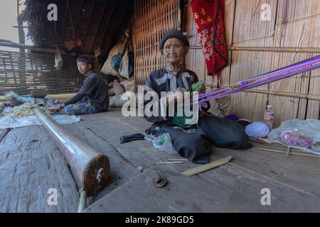Lahu woman seen weaving outside her home in Chiang Mai. The Lahu and ...