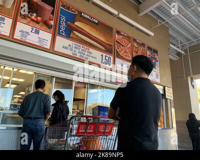 Beijing, Hebei, China. 15th Oct, 2022. Customers wait in line to order below signage for the Costco Kirkland Signature $1.50 hot dog and soda combo, which has maintained the same price since 1985 despite consumer price increases and inflation, at the food court outside a Costco Wholesale Corp. store in San Jose, California. (Credit Image: © David G. McIntyre/ZUMA Press Wire) Stock Photo