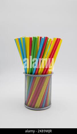 Drinking straws in a metal container,isolated on a white background. Stock Photo