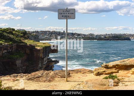 A sign for the Lifeline suicide prevention crisis hotline at the Shark Point cliffs in Clovelly, Sydney, Australai Stock Photo