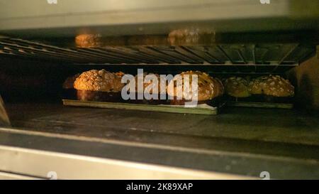 group of panettone cakes baking in the pro oven at the baker Stock Photo