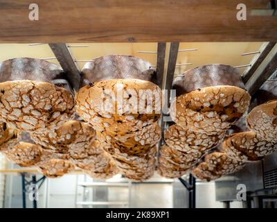 panettone cooking secrets concept hanging up down in the kitchen Stock Photo