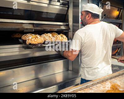 group of panettone cakes baking in the pro oven at the baker Stock Photo