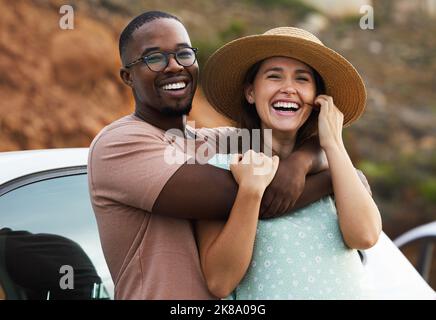 Lots of miles, lots of smiles. Portrait of a happy young couple enjoying a romantic road trip. Stock Photo
