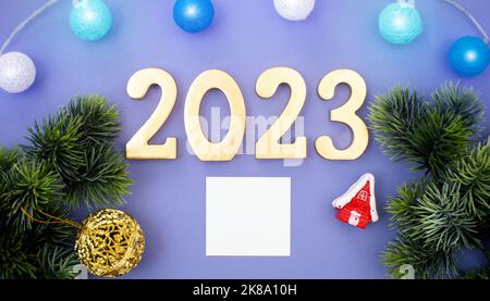 Christmas tree branches with paper card note. Flat lay. Nature New Year concept. Stock Photo