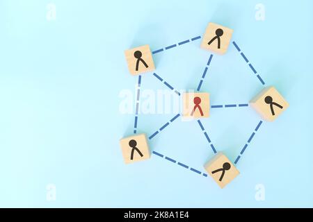 Social connections, teamwork and network in business concept. Interconnected wooden blocks flat lay composition on blue background. Stock Photo