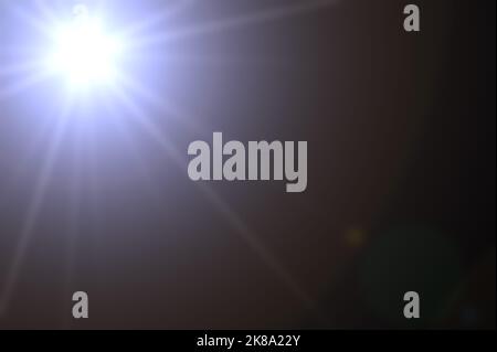Realistic lens flare in black background. Lens Flare. Blue Light over black background. add overlay or screen filter over images. Abstract sun burst w Stock Photo