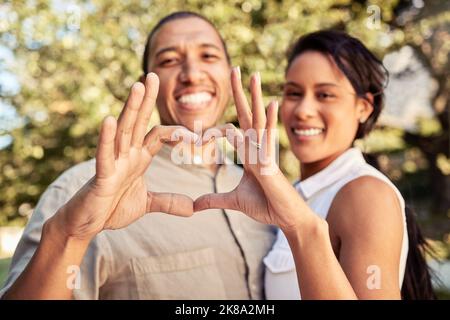 Hands, heart and love with a black couple sign outdoor in the garden of their home together. Happy, hand and romance with a man and woman making a Stock Photo