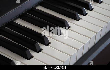 Close up of the white and black keys on an electronic piano. Diagonal view of piano keys Stock Photo