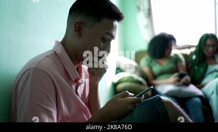 One hispanic man reading shocking news on cellphone. Person receiving unbelievable message notification Stock Photo