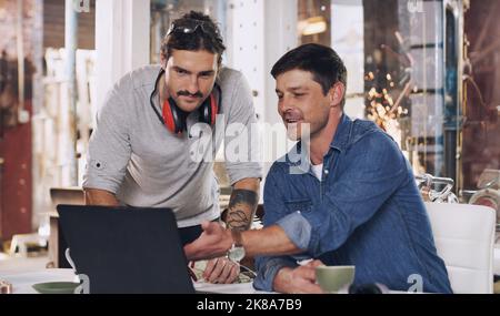 Heres some great reviews on the project you worked on. two men discussing something on a laptop in their workshop. Stock Photo