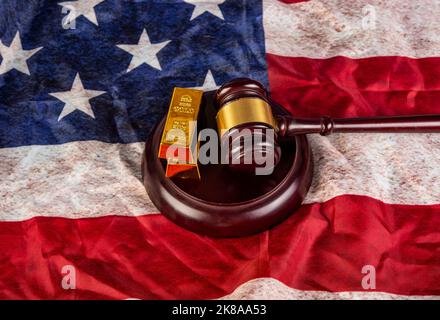 Gold bars with gavel on USA flag background. Stock Photo