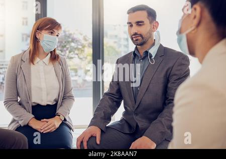 Covid, business people and office meeting with leader, manager or coach talking for counseling, therapy or support. Corporate women and man group with Stock Photo
