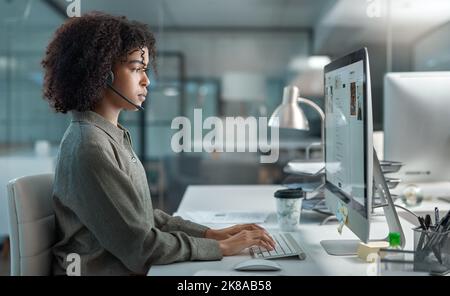 Follow one course until sucess. a young female agent working in a call centre focused while typing. Stock Photo
