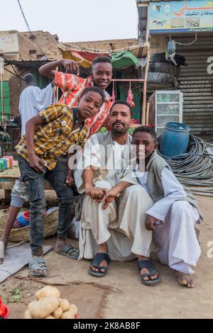 SHENDI, SUDAN - MARCH 5, 2019: Man with boys on a street in Shendi, Sudan Stock Photo