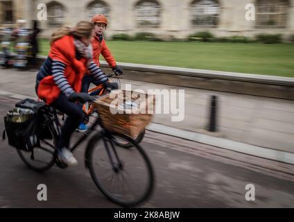 Students Cycling Past Universities n Cambridge UK Stock Photo