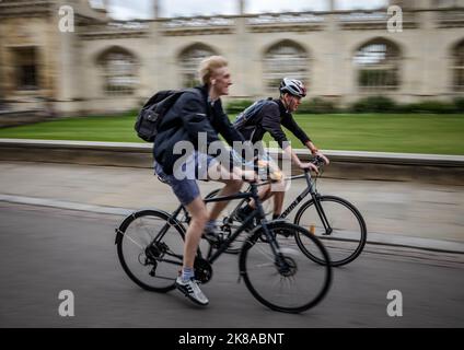 Students Cycling Past Universities n Cambridge UK Stock Photo