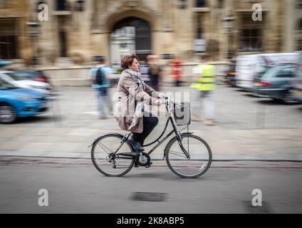 Students Cycling Past Universities n Cambridge UK Stock Photo