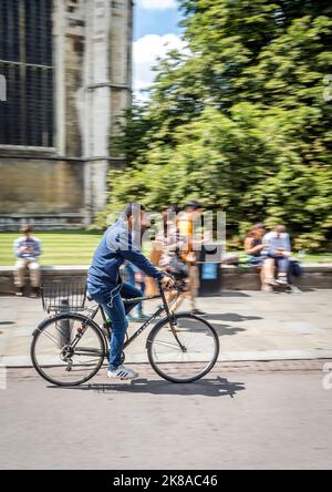 Students Cycling Past Universities n Cambridge UK Stock Photo