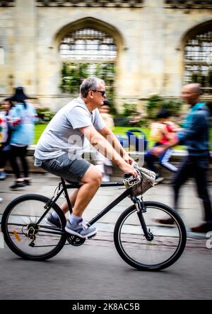 Students Cycling Past Universities n Cambridge UK Stock Photo