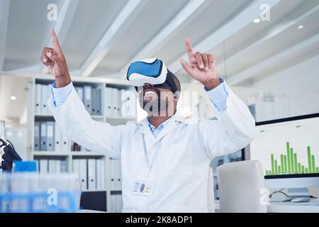 Science changes the way you see the world. a mature scientist using a virtual reality headset while working in a lab. Stock Photo