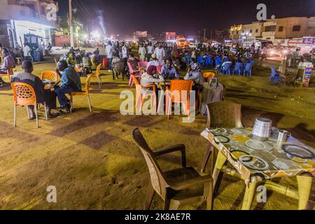 OMDURMAN, SUDAN - MARCH 6, 2019: People sit at the open air restaurant tables in Omdurman, Sudan Stock Photo