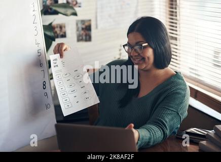 Online learning is still learning. a young woman using a laptop to teach a lesson from home. Stock Photo