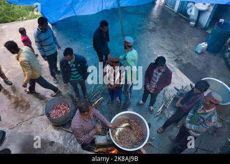 Community cooking and feast in a Himachal village in North India Himalaya. Villagers belong to a single family clan with extremely close knit  ties. Stock Photo